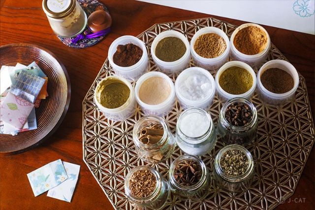 Selection of natural essential oils and aromatic ingredients arranged for a personalised aroma blending session at a Tokyo atelier.