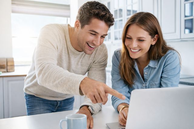 Couple browsing a travel website together while planning cultural experiences in Japan