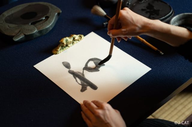 Japanese Zen calligraphy practice using traditional tools in Asakusa, Tokyo