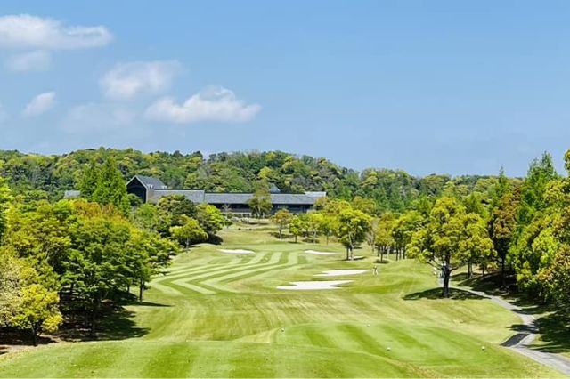 Scenic golf course in Japan surrounded by trees with fairway leading toward clubhouse